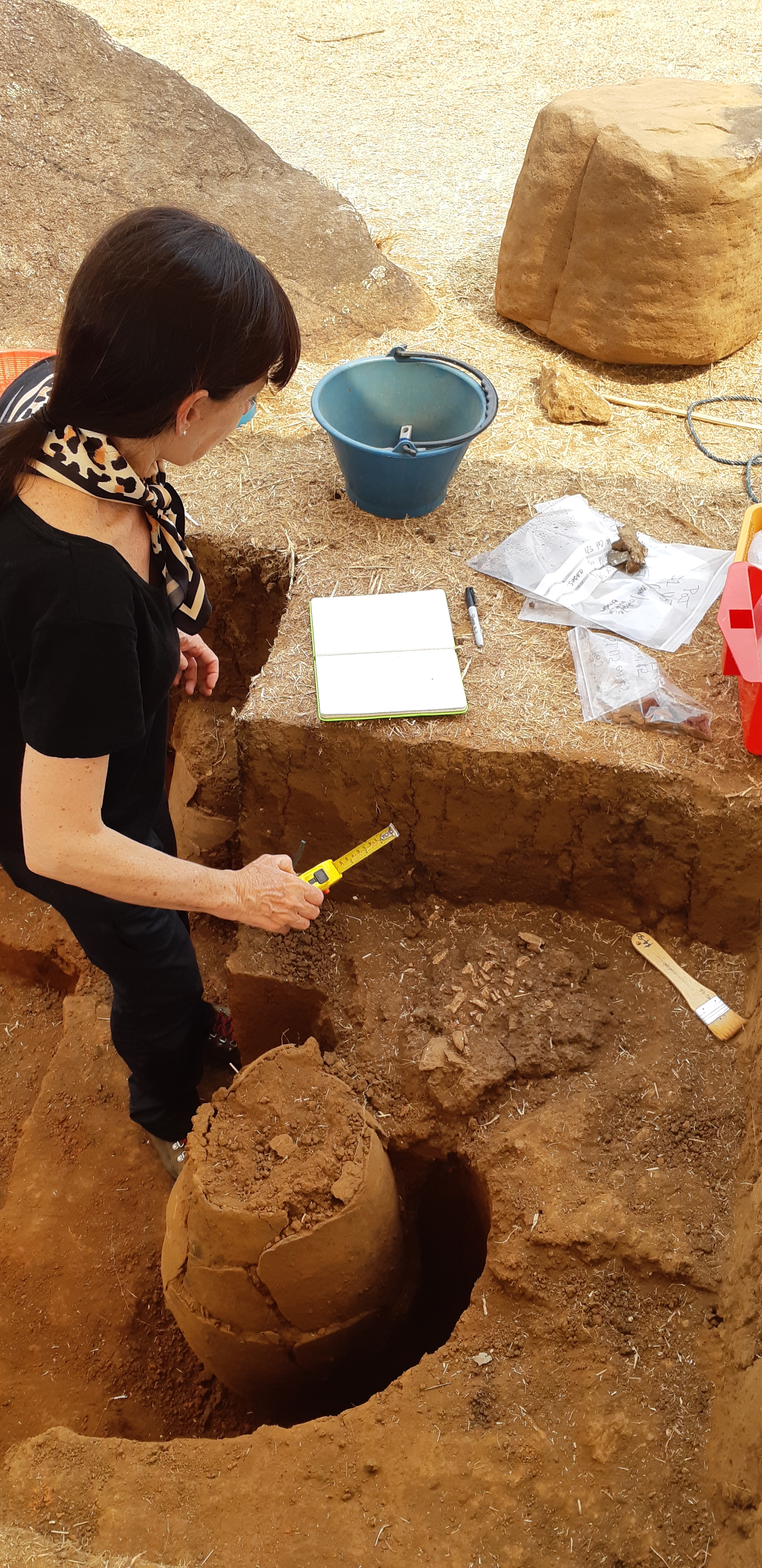 Excavating a ceramic jar burial at the Plain of Jars in Laos