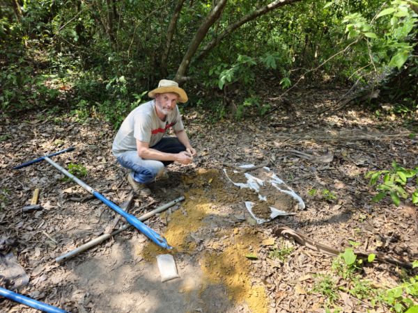 Man looking through soil samples pulled from auger.